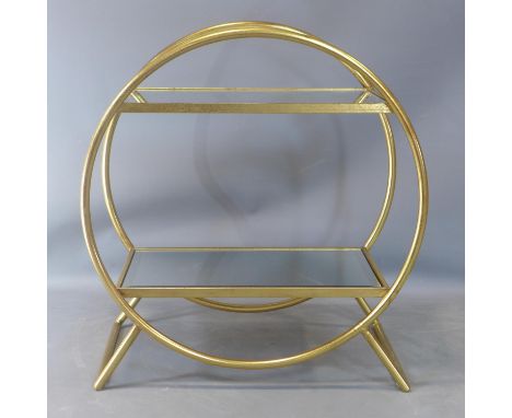 A Maison Jansen style gilt two tier shelf, with bevelled mirrored tops, having a circular frame, on splayed legs, H.74 W.69 D