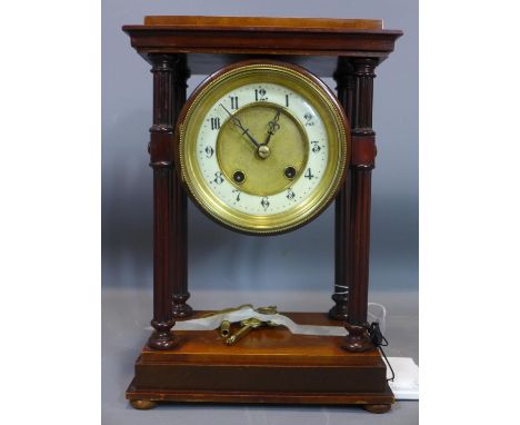 A 20th century mantel clock, with four reeded columns, on stepped rectagangular base, the white chapter ring with Arabic nume