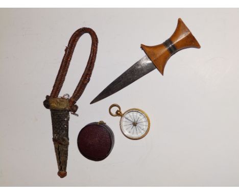 A cased gilt metal compass and a small Eastern dagger. (2)