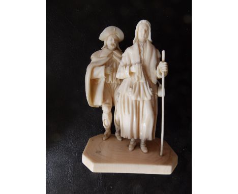 A 19thC continental ivory figure group, depicting a peasant couple, the woman leading her elderly husband in her right arm, h