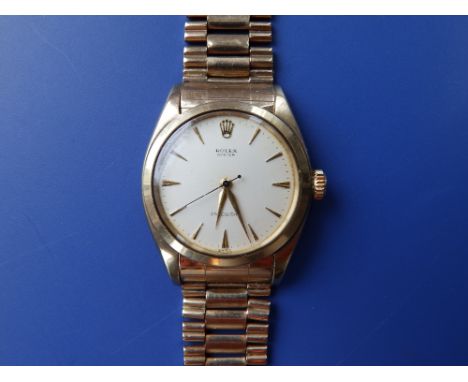 A gent's 9ct gold Rolex Oyster Precision bracelet wrist watch, having gold baton numerals and centre seconds – the Rolex gold