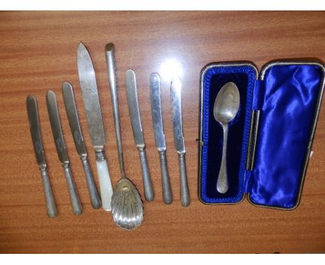 A cased Sheffield silver christening spoon, a serving spoon, a mother-of-pearl handled knife and six tea knives. (9)