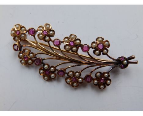 A French yellow metal leaf brooch set with pearls & ruby coloured stones.