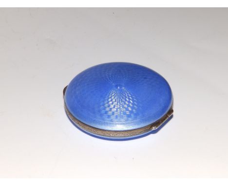 A continental enamelled silver circular powder compact, having blue guilloche enamel cover and underside, engraved decoration