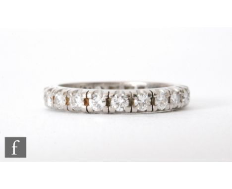 An 18ct hallmarked white gold diamond full eternity ring comprising twenty two claw set brilliant cut stones, total weight ap