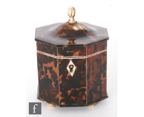 A 19th Century hexagonal tortoiseshell tea caddy terminating in domed hinged cover below bone finial, all raised on four conf
