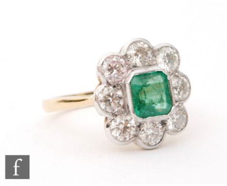 An 18ct emerald and diamond cluster ring, central emerald cut emerald, collar set within an eight stone brilliant cut diamond