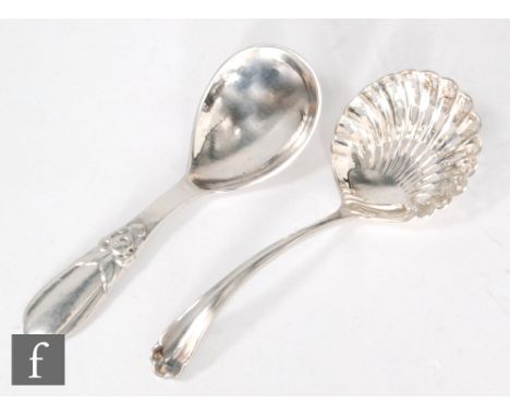 A Danish silver caddy spoon with planished ground and floral detail, Evald Nielson, with a hallmarked silver shifter spoon, S