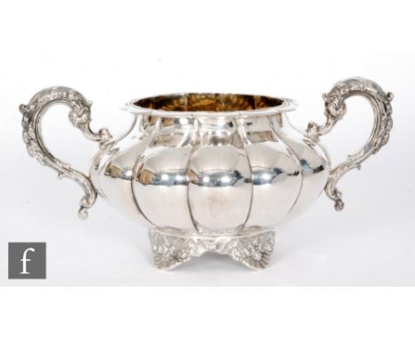 A 19th Century hallmarked silver twin handled sugar basin of melon form, raised on four shell feet, weight 14oz, London 1837,