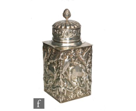 A Victorian hallmarked silver square sectioned tea caddy with foliate embossed birds, foliate scroll and swags below a pull c