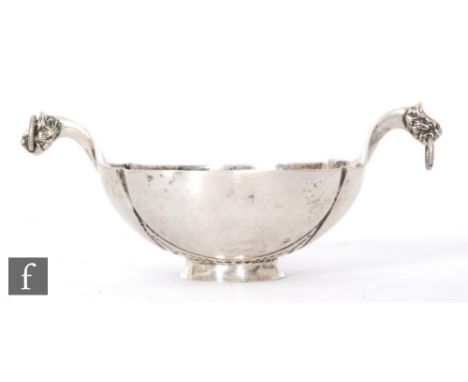 A Russian silver small bowl with panelled decoration terminating in dragon head terminals to twin handles, diameter 7cm, impr