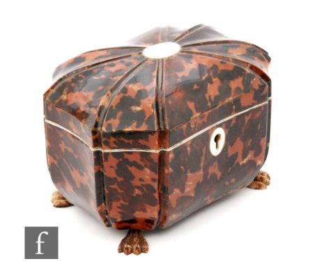 A 19th Century tortoiseshell sarcophagus tea caddy with laid mother of pearl escutcheon and cartouche, raised on carved bone 