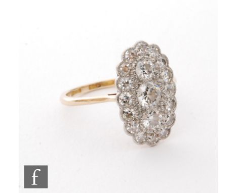 An 18ct diamond cluster ring, three vertically set brilliant cut diamonds within a shaped diamond border, all to knife edged 