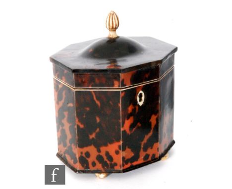 A 19th Century hexagonal tortoiseshell tea caddy terminating in domed hinged cover below bone finial, all raised on four conf