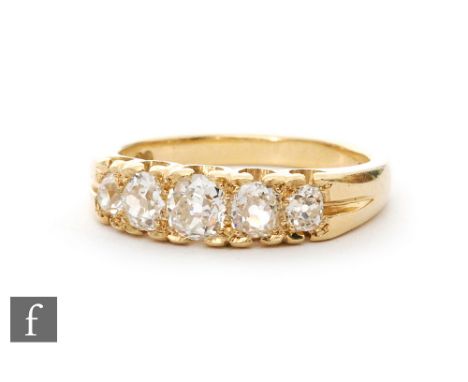 An 18ct hallmarked diamond five stone ring, old cut claw set stones, largest approximately 0.65ct, ring size X. 