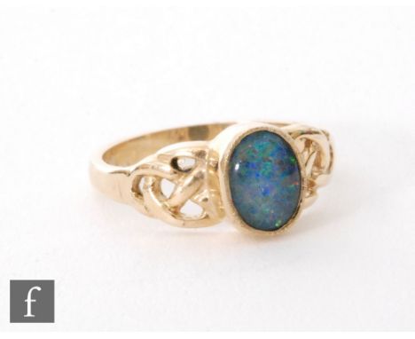 A 9ct hallmarked single stone opal triplet ring, oval collar set stone to Celtic style shoulders, ring size O. 