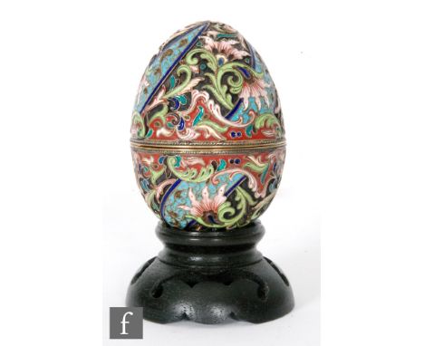 A Russian silver and cloisonne enamel Easter egg decorated in tonal red, green and blue foliate scrolls, length 7.5cm, possib