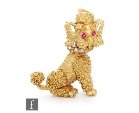 An 18ct hallmarked brooch modelled as a seated poodle with diamonds set collar and ruby set eyes, height 3cm, weight 10.5g, a
