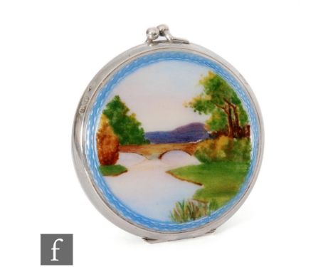 A hallmarked silver circular purse compact decorated with an enamelled river scene to front, diameter 5cm, Birmingham 1929, R