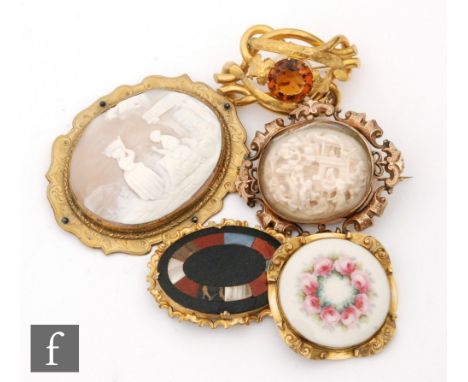 Five 19th Century gilt mounted brooches to include a Worcester porcelain, a cameo and a quartz example, largest width 10cm, S