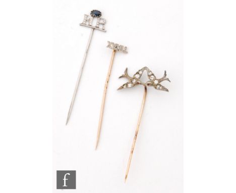 Three early 20th Century diamond set stick pins two with initials, the other modelled as two birds in flight. (3) 