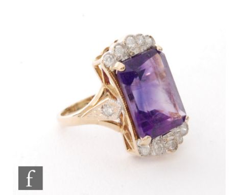 A 9ct hallmarked amethyst and diamond ring, central rectangular cut amethyst, length 12mm, flanked above and below by diamond