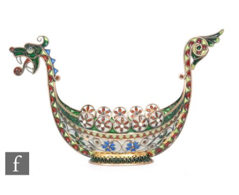 A Norwegian silver gilt plique a jour study of a Viking boat decorated with flower heads around a blue enamel well, terminati