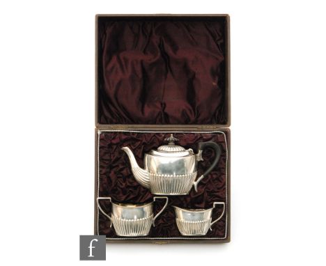 A Victorian cased hallmarked silver bachelor's boat shaped tea set with part fluted decoration, total weight 13.8oz, Birmingh