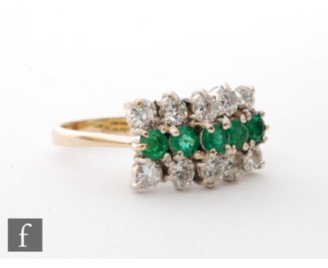 An 18ct hallmarked emerald and diamond claw set ring, central row of five emeralds flanked above and below by five diamonds, 