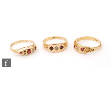 Three early 20th Century 18ct ruby and diamond boat shaped rings, two gypsy set and the third a seven stone boat shaped examp