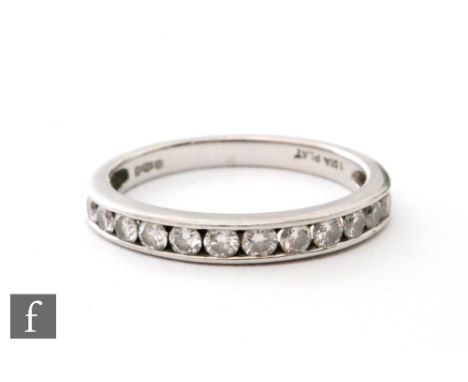 A platinum diamond half eternity ring, brilliant cut channel set stones to a plain shank, ring size N. 