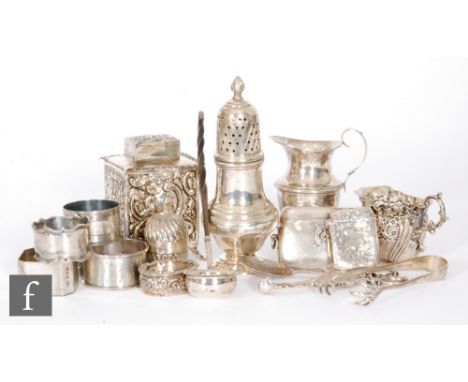 A small parcel lot of assorted hallmarked silver items to include a tea caddy, sugar castor, two cream jugs, vesta cases, nap