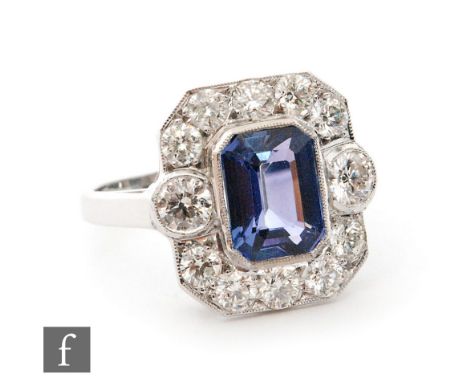 An 18ct white gold tanzanite and diamond cluster ring, central emerald cut collar set tanzanite, weight approximately 2.5ct, 