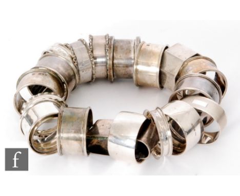 Twenty assorted hallmarked silver napkin rings, total weight 10oz, various styles and dates. (20) 