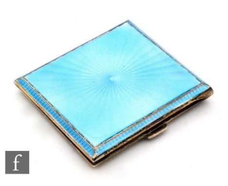 A mid 20th Century silver hallmarked and guilloche enamel cigarette case, the star burst design blue enamel outer case reveal