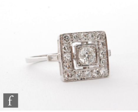 An 18ct white gold diamond cluster ring, central old cut stones within a square diamond set border, ring size O. 