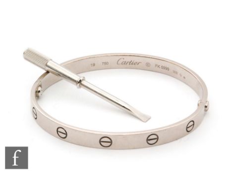 An 18ct white gold Cartier Love bangle detailed with screw heads and signed Cartier, stamped 750 with Swiss control marks, nu