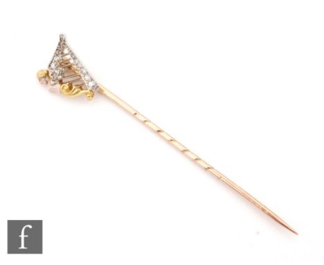 A 19th Century 18ct diamond set stick pin modelled as a harp with an enamelled female figure head to on side, length of head 