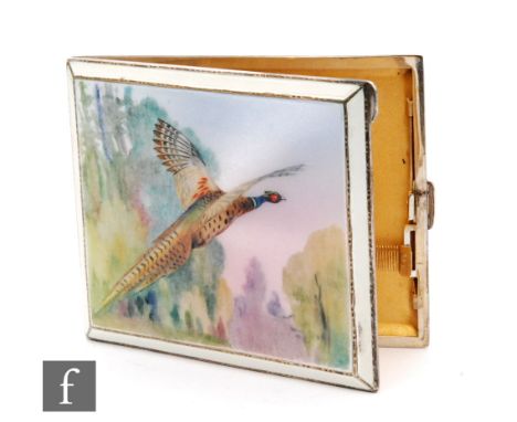 A mid 20th Century silver and guilloche enamel cigarette case, painted with a pheasant in flight, the hinged cover revealing 