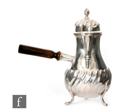 A Victorian hallmarked silver chocolate pot raised on three pad feet with part fluted decoration and turned wooden side stick