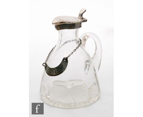 An Edwardian hallmarked silver and clear glass toddy water jug, clear glass body below silver collar and hinged cover, height