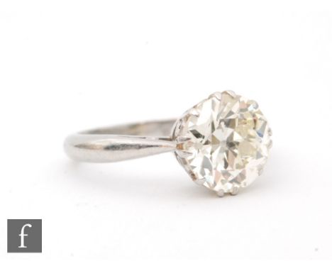 A platinum diamond solitaire ring, old cut claw set stones weight 4.20ct, colour L/M, clarity I1, to tapering plain shoulders