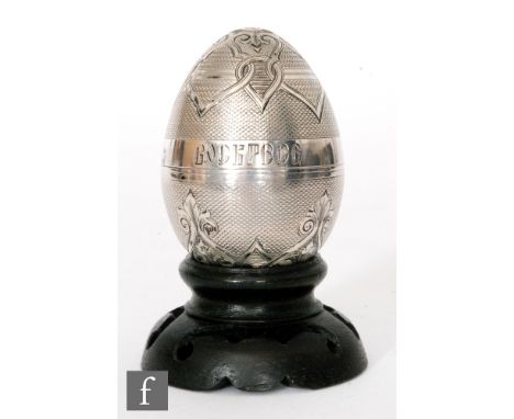 A Russian silver Easter egg with engine turned and part engraved foliate details with Christ is Risen engraved in Cyrillic to