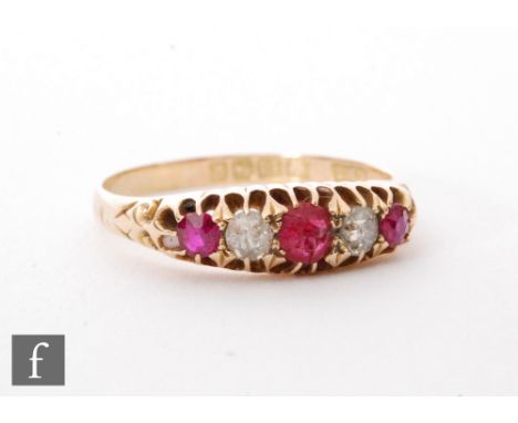 An 18ct hallmarked ruby and diamond five stone, boat shaped ring, alternating claw set stones, Birmingham 1909, ring size T. 