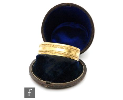 An early 20th Century oval bangle with wire work and shot details to border, length 6cm, weight 18.5g, unmarked probably 15ct