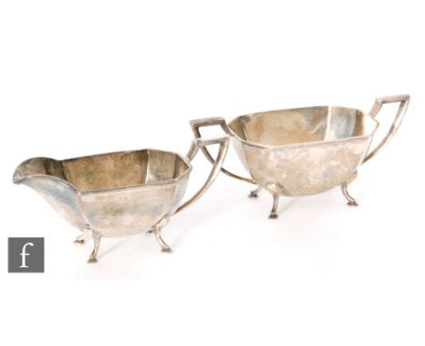 A hallmarked silver cream and sugar basin each of panelled boat shaped form, each raised on four pad feet, total weight 12.5o