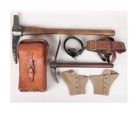 Military Equipment: Large pick axe , entrenching tool stamped with arrow, officers Sam Brown belt, brown leather magazine pou