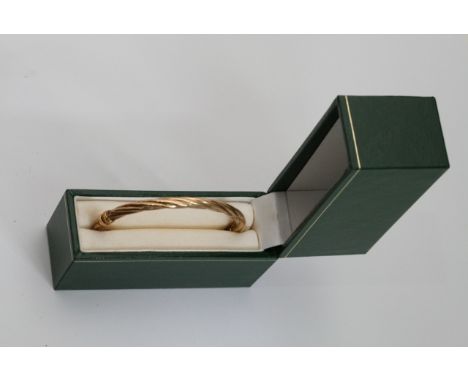 A 9ct gold twist bangle