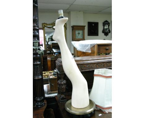An unusual electric table lamp in the form of a ladies leg on a base, includes shade.