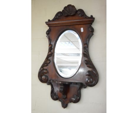 A small Edwardian Wall Mirror with shell carving oval mirror and applied shelf 60cm by 40cm